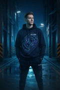 FLUX Arena Map heavyweight hoodie and matching jogger, glowing blue arena graphics, worn in a neon-lit alley