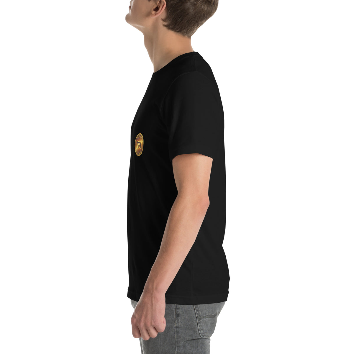 Left-side model view of the black FLX V-Money Coin Tee, with the small gold-coloured chest coin partly visible.
